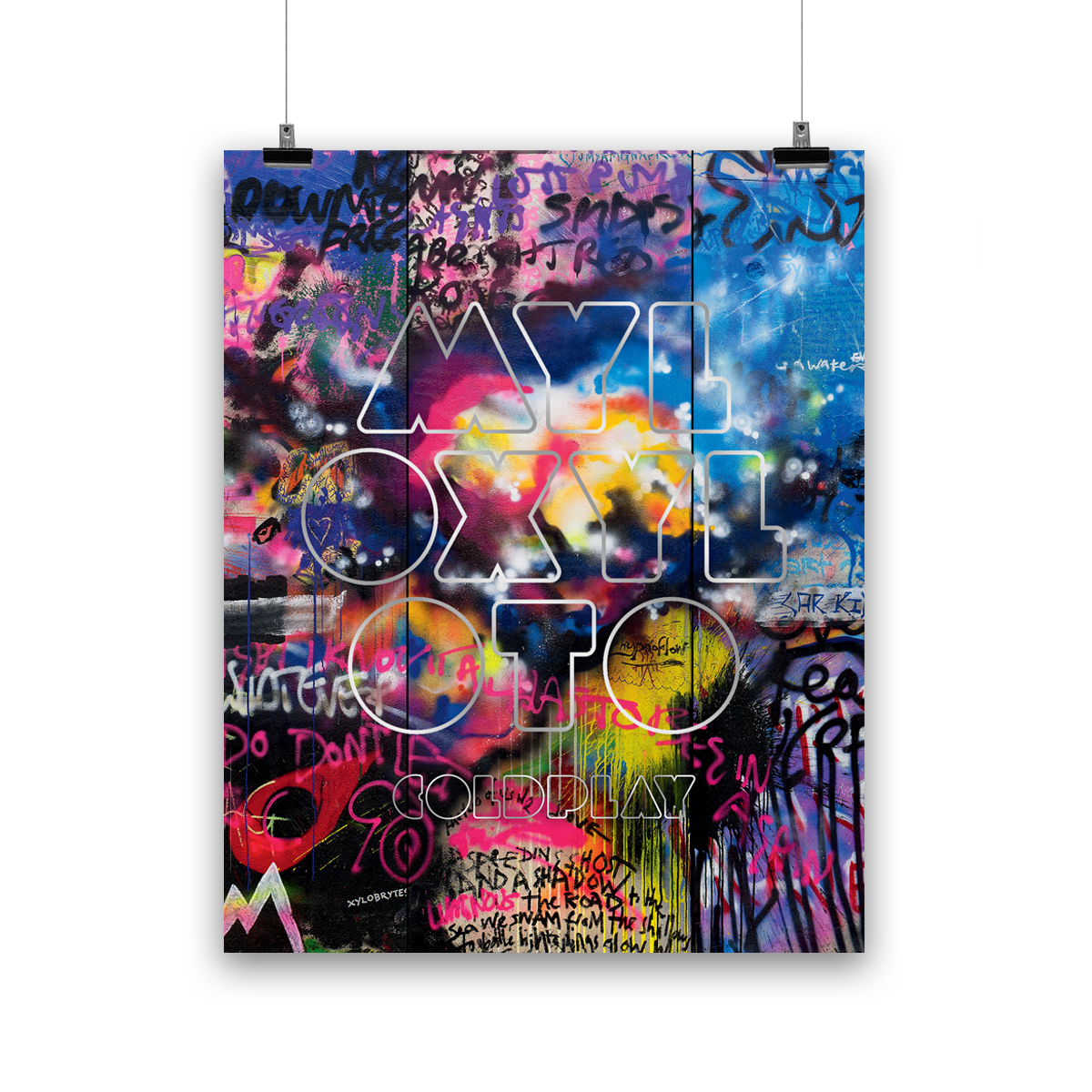 GraffitiWall with darkGreen, neonYellow, red, blue, purple, beige&orangePatches. A cloudLikeCollection of white, yellow, orange, brightPink&magenta looks like aHeartHadOnce beenThere. On a lightBlueSplotch is anOutline of a🦋in darkBlue. UP WITH THE BIRDS is writtenNear. We see a lightPink&darkBlueSection withWhiteBehindIt. RainbowColoredBlobs, butDuller. WhiteStripes. A darkRed👁️like a teardrop. A letter M like a⛰️in lightBlue, yellow&pink. MYLO XYLOTO written inChunky, silverOutline sprayLetters